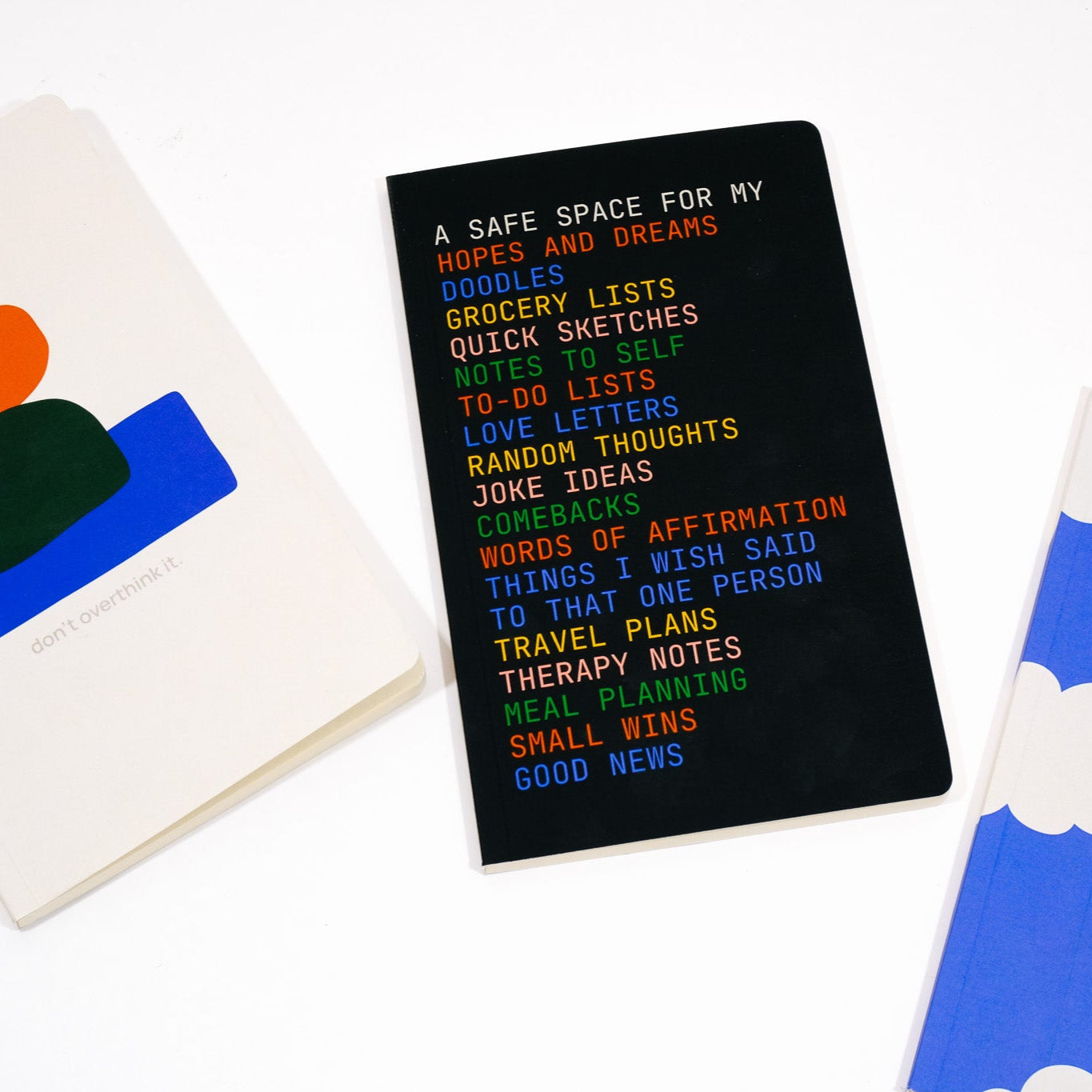 Three notebooks with different designs on a white background